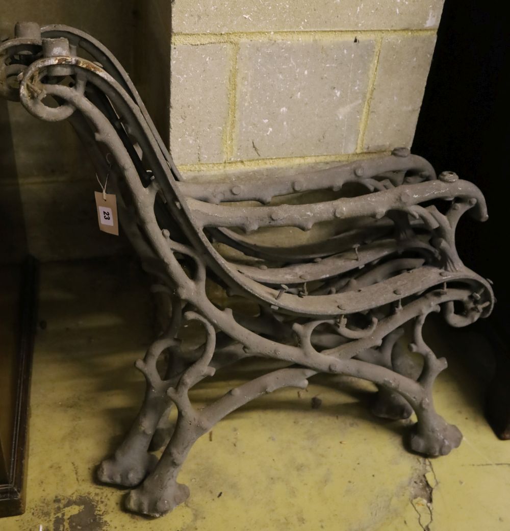 A pair of Victorian cast iron rustic bench ends and a matching central support